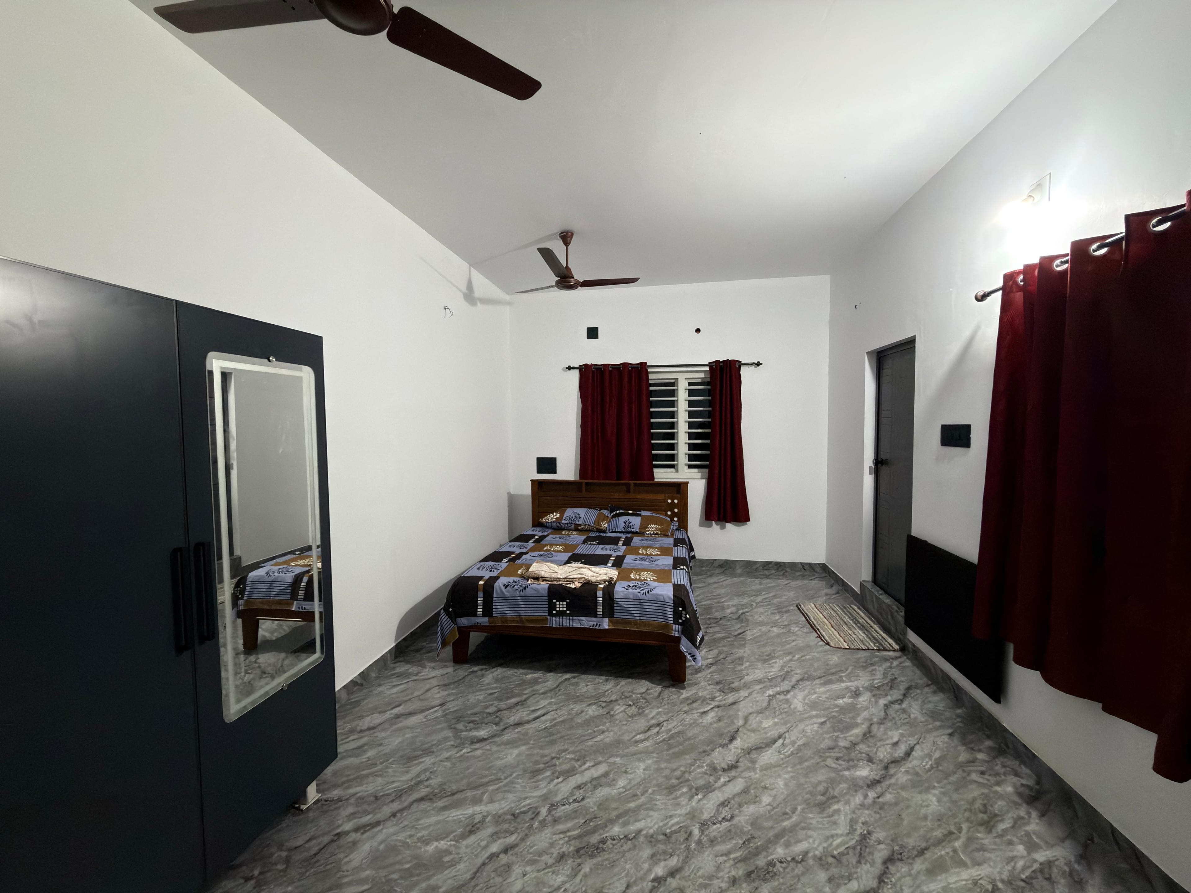 Cozy master bedroom with attached bathroom at Arena Gardens farm stay in Sreekrishnapuram